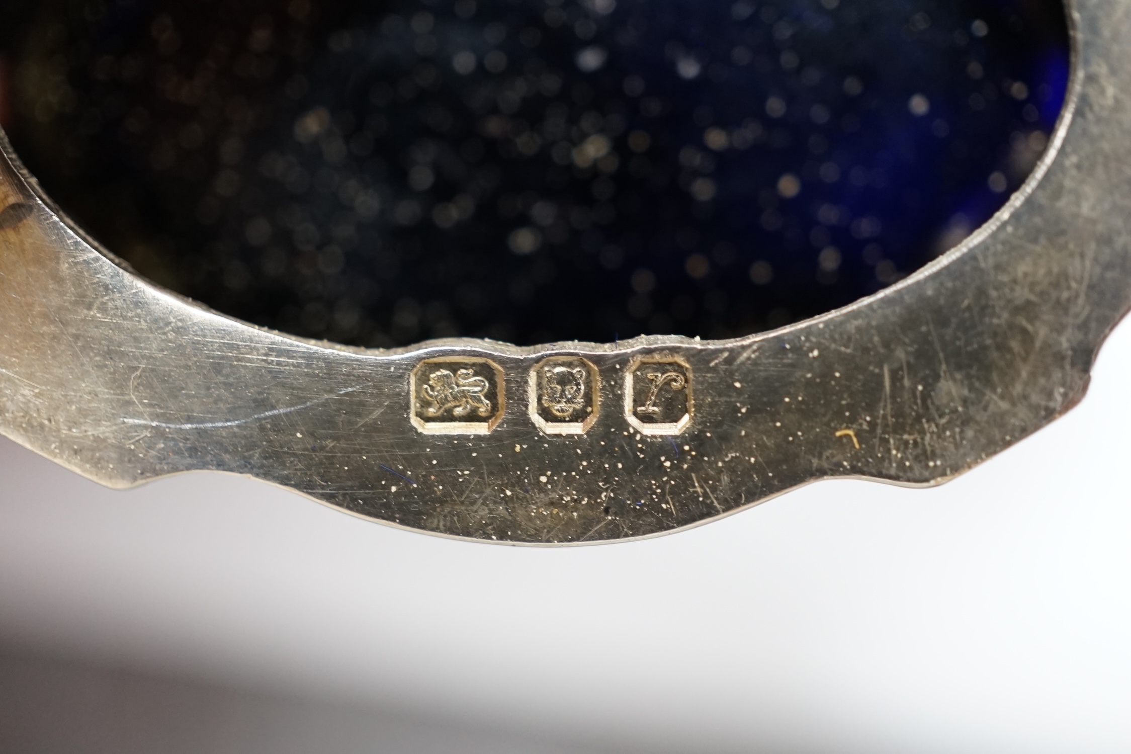 A cased 1970's silver three piece condiment set and two spoons by A. Chick & Sons, London, 1972, with blue glass liners (chipped). Condition - poor to fair